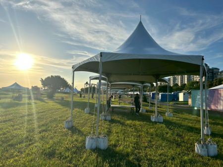 Hexagonal Tents Along the Riverside Lawn